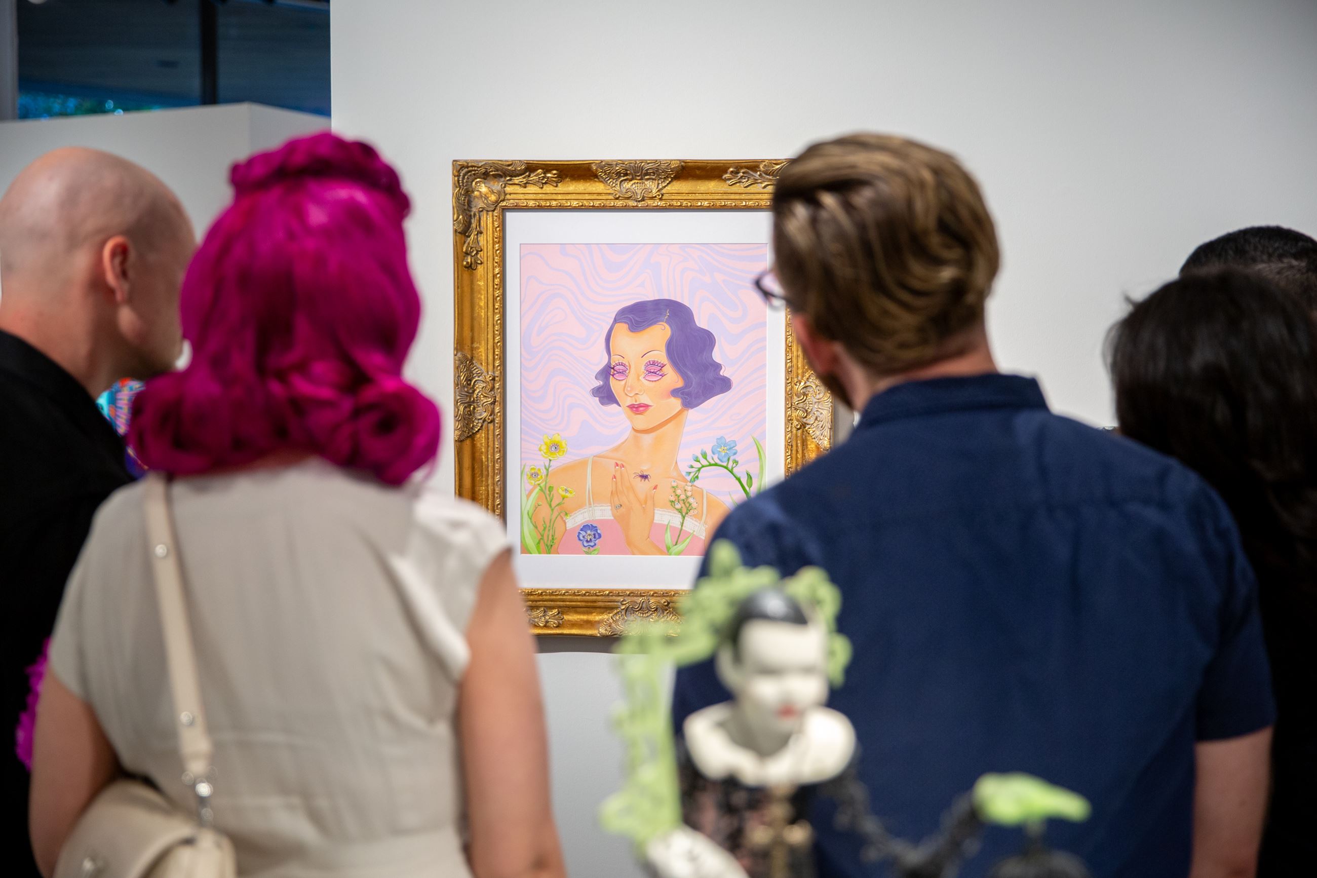 People staring at painting at Brea Gallery